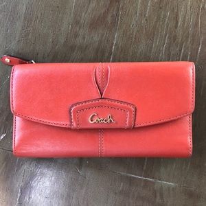 Orange Coach tri-fold wallet